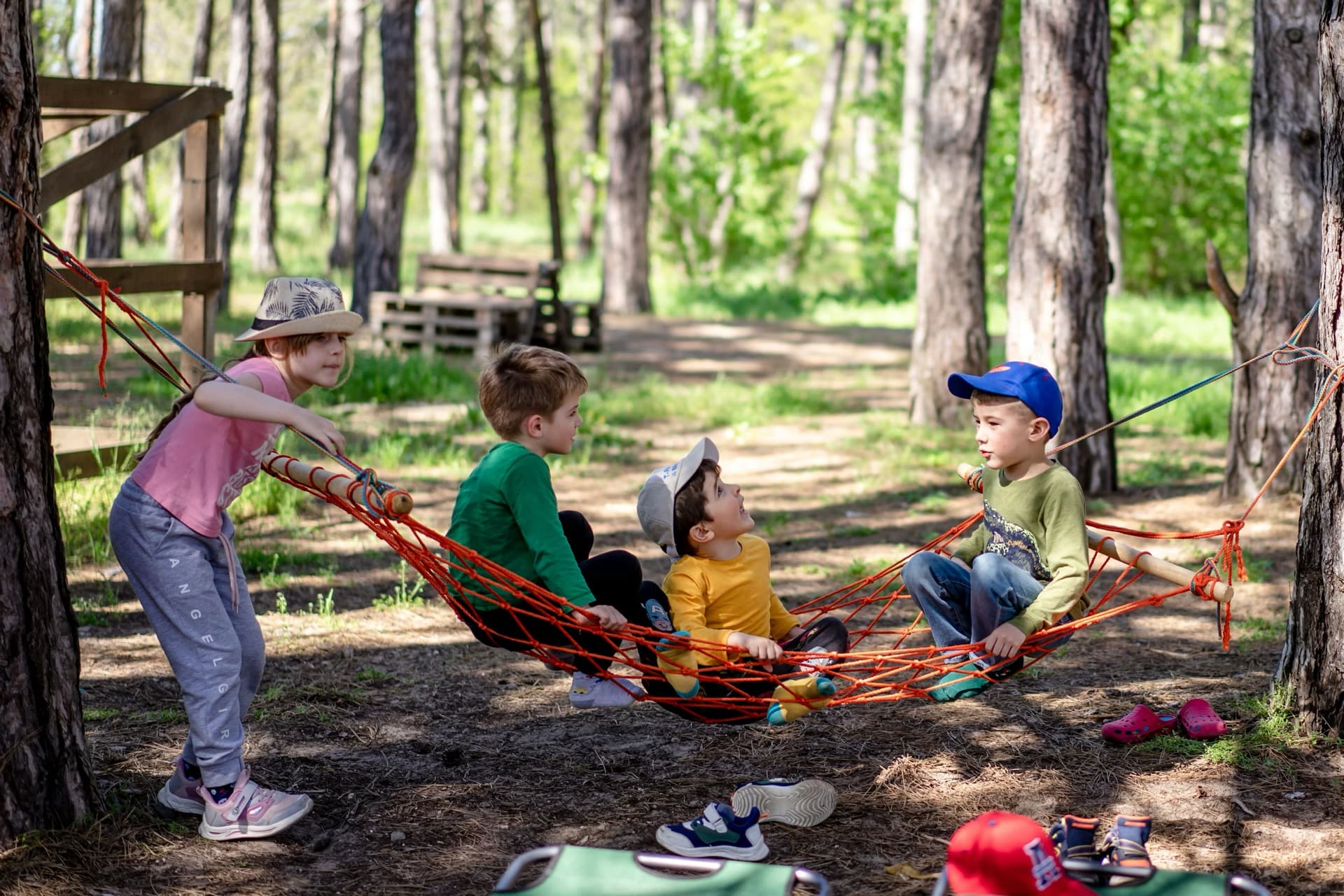 Kids laughing in a forest hammock